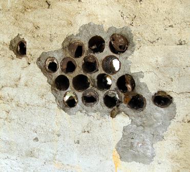 Interior wall detail in Cone Cabin  (Bottles were often used as filler in walls).